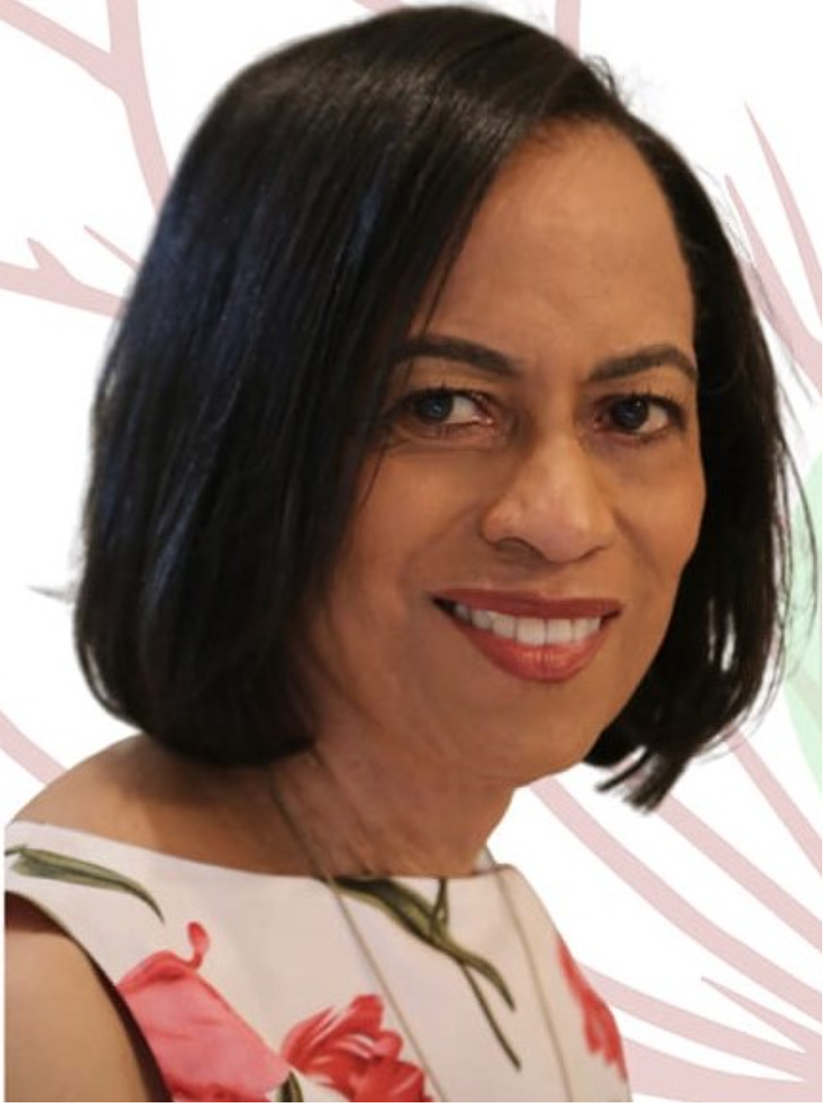 A woman with dark hair and a bright smile, wearing a white top.